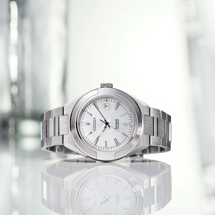 Citizen Series Eight NA1000-88A Mechanical Men's Watch, Stainless Steel Case, White Dial, Stainless Triple Link Band,Image cut on the table.