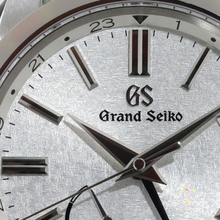 Grand Seiko SBGE279 Spring Drive GMT Close-up of the silvered dial with organic stamped pattern.