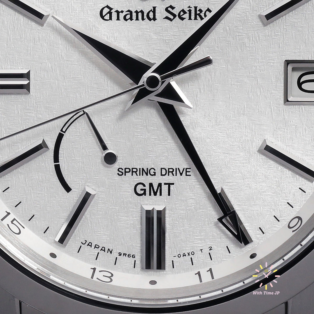 Grand Seiko SBGE279 Spring Drive GMT Close-up of the silvered dial with organic stamped pattern and GMT hands.