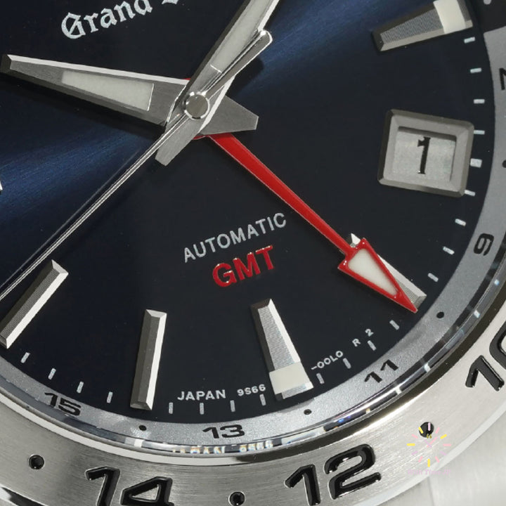 Grand Seiko SBGM245 Automatic GMT Men's Watch with close-up of GMT hand.